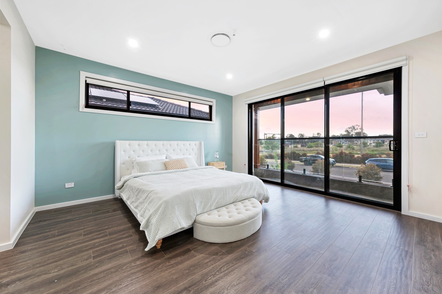 Sydney TCE main bedroom with balcony glazing and soft green feature wall